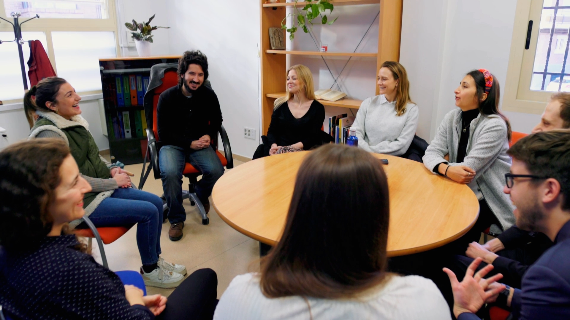 Preview image for the video "Teach For All's Europe Alumni Leadership Fellowship" - Several young men and women sit around a table in discussion.