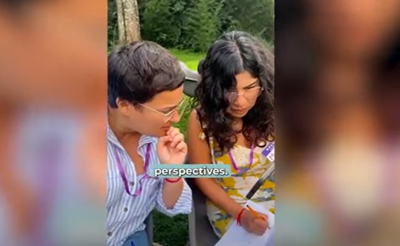 Preview image for the video "Education in Emergencies: Local Roots, Global Strength" - Two women with brown hair look at a paper together.