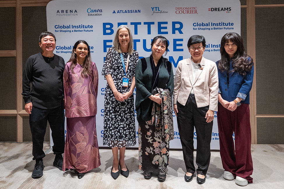 Six people stand smiling in a row at a formal event in front of a white backdrop reading "BETTER FUTURE FORUM" and "Global Institute for Shaping a Better Future."