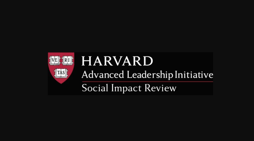 The logo for the Harvard Advanced Leadership Initiative Social Impact Review set against a black background. On the left is the Harvard crimson shield featuring three white open books that spell out "VE-RI-TAS." To the right of the shield, the white serif text reads "HARVARD" on the top line, followed by "Advanced Leadership Initiative" on the second line. A thin crimson horizontal line separates the second line from the third, which reads "Social Impact Review."